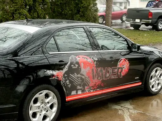 Black sedan with a large red side graphic