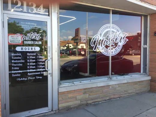 Glass entry door and window with business hours and logo graphics