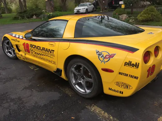 Yellow sports car with black stripe graphics